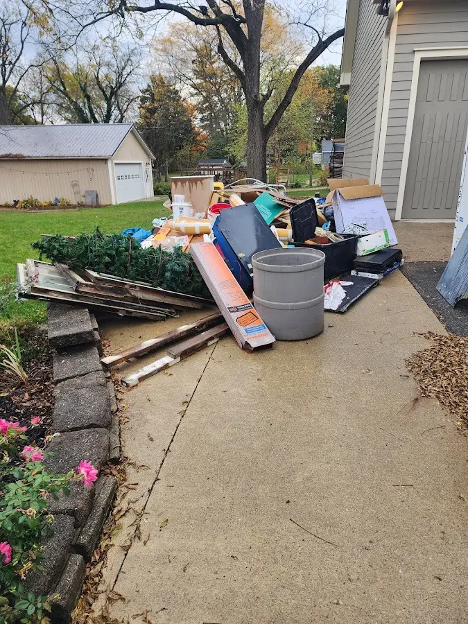 Dumpster being loaded with debris for Roofing Dumpster Rental in Naples Park